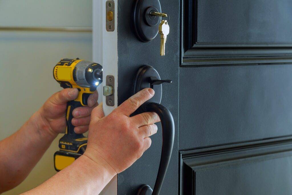 closeup-of-a-professional-locksmith-installing-a-new-lock-on-a-house-exterior-door-with-the-inside-1024x683
